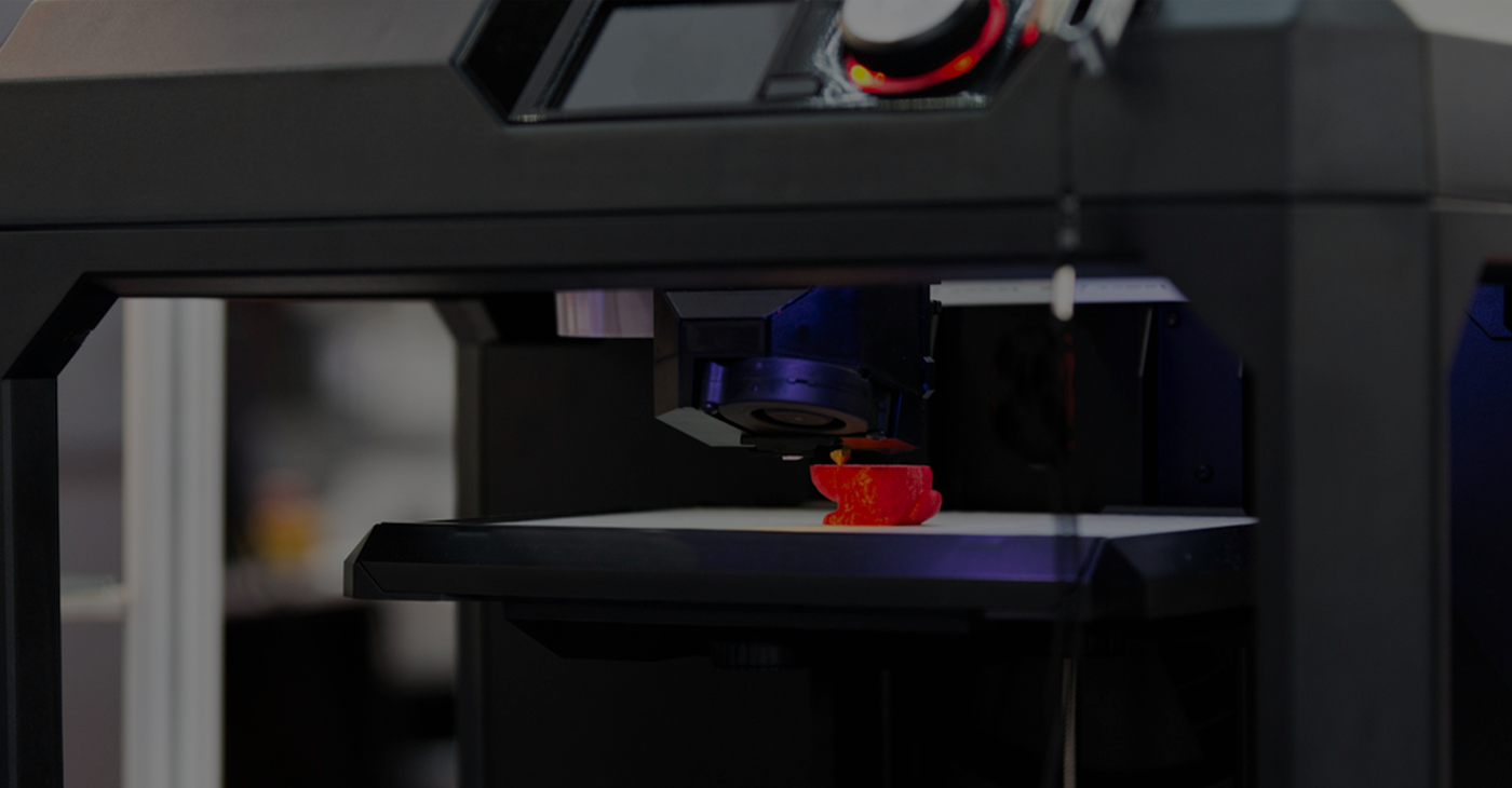 3D Printer creating a red object