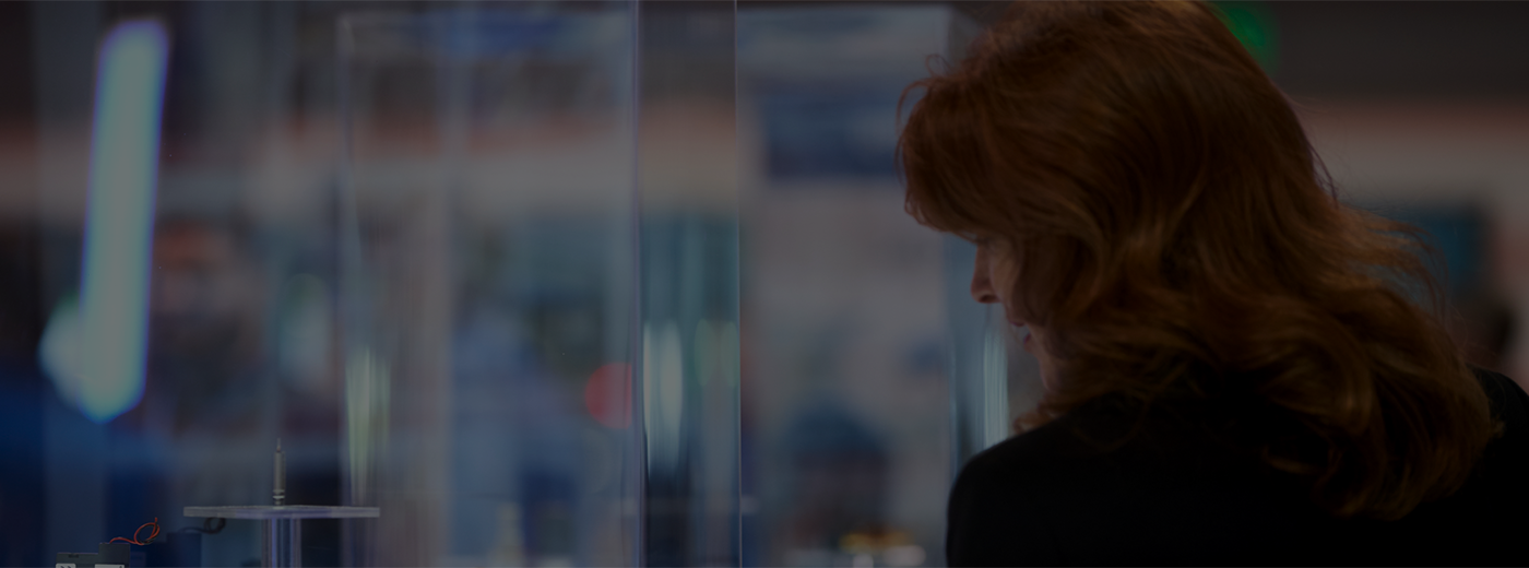 Woman looking at machine in display