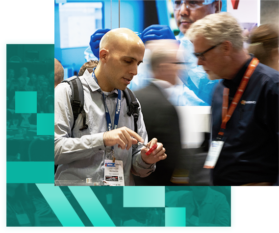 Two attendees examining a product in the expo hall floor